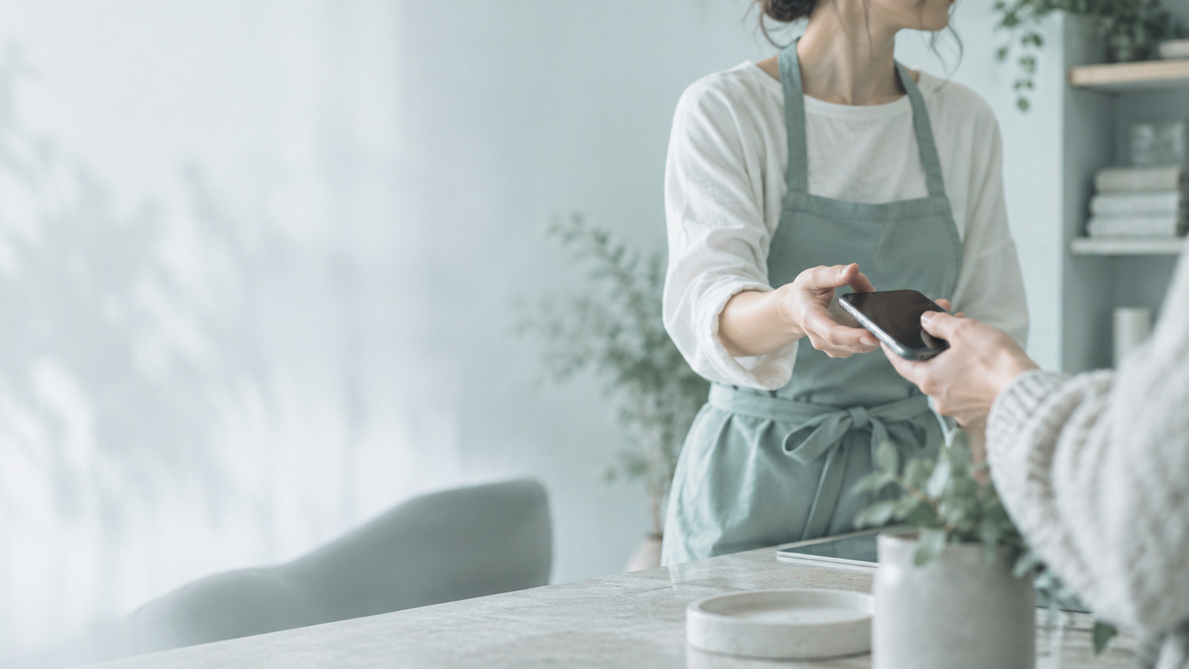 Service business owner reviewing AI customer experience dashboard on a tablet